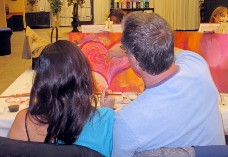 A local couple enjoys a paint and sip date night