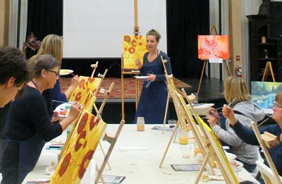 Julia Ward guides students in painting sunflowers