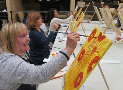 Participants at a past Sunflowers paint and sip