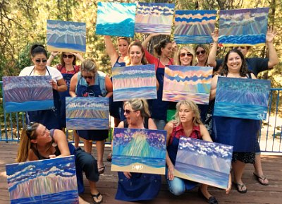 Group of ladies show off their finished paintings
